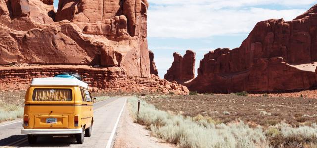 Yellow Volkswagen van on road in desert